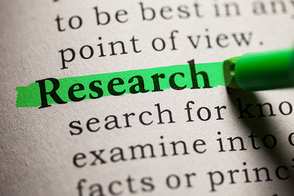 This shows the page of a printed text book with the word Research highlighted with a green highlight pen.