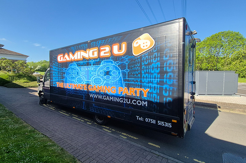 The Gaming Bus - A large sign-written blue van with Gaming 2 U written on the side.